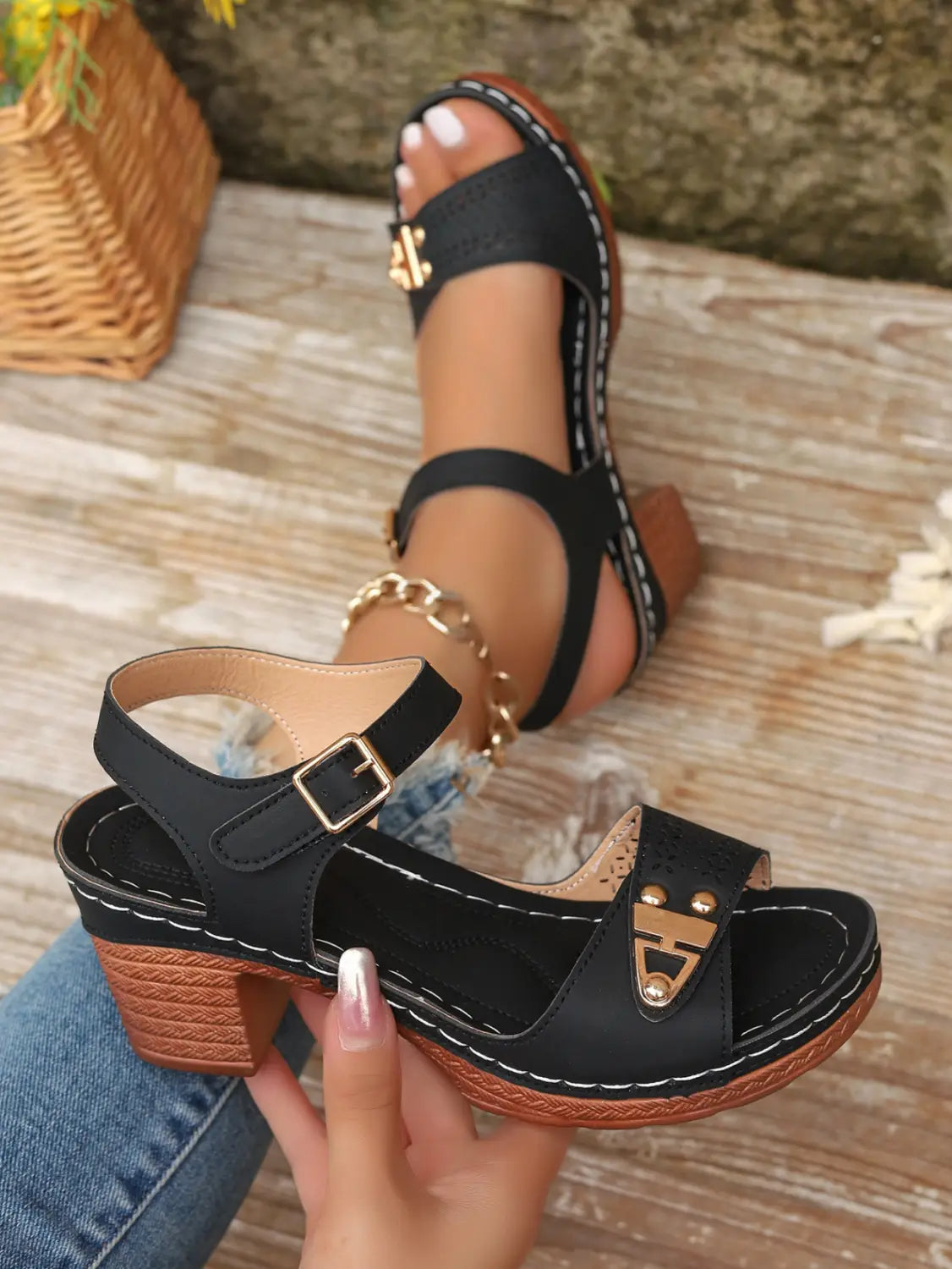 Black chunky heel platform sandals with gold-tone metal accents, woven textured sole, buckle closure, and pigskin lining.