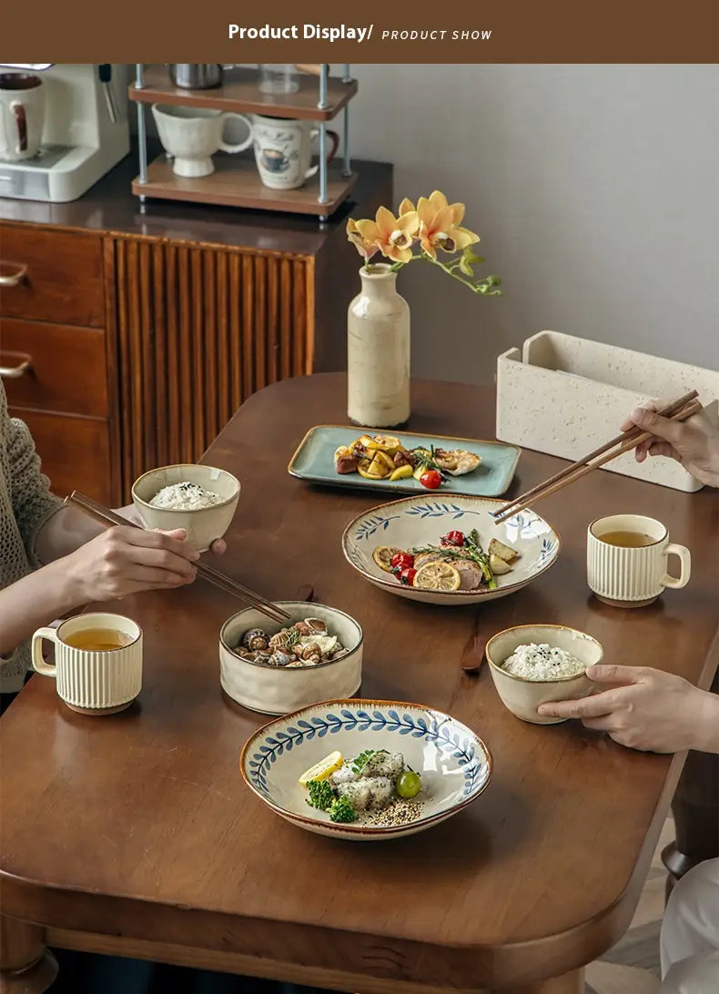 A handcrafted 9-inch ceramic deep plate featuring earthy tones, delicate blue leaf patterns along the rims, and a rustic textured finish.