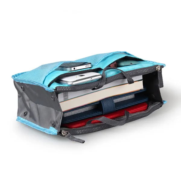 A turquoise and gray multi pocket nylon handbag organizer with dual zippers and a sturdy mesh design for holding phones books and notebooks.