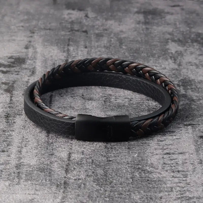 Black braided leather men’s bracelet with a magnetic clasp displayed on a white background.