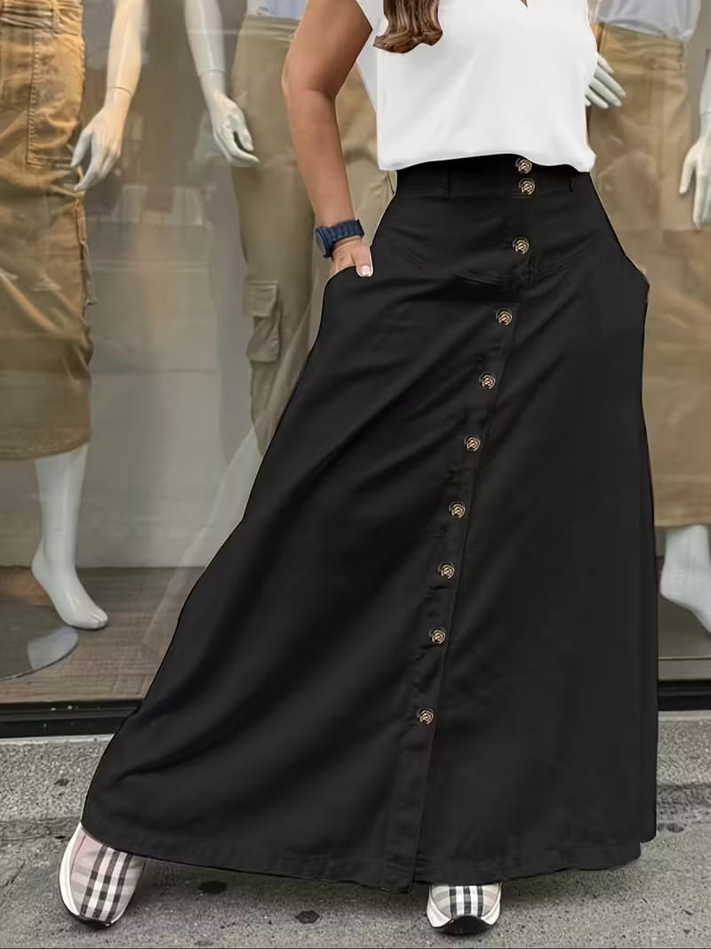 Jupe longue maxi noire boutonnée devant à taille haute, à coupe droite et poches latérales, adaptée à un usage décontracté et formel.