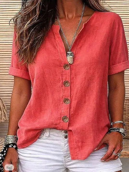 Coral-colored short sleeve button up cardigan for women with a relaxed fit and rolled cuffs.