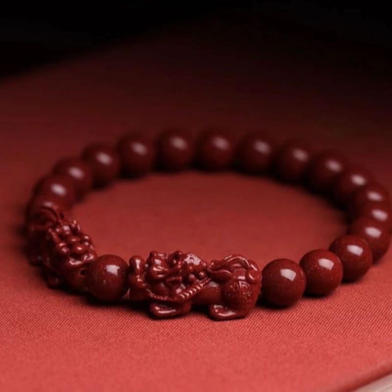 hand carved purple gold cinnabar double pixiu bracelet with deep red polished wooden beads and a detailed carved dragon centerpiece