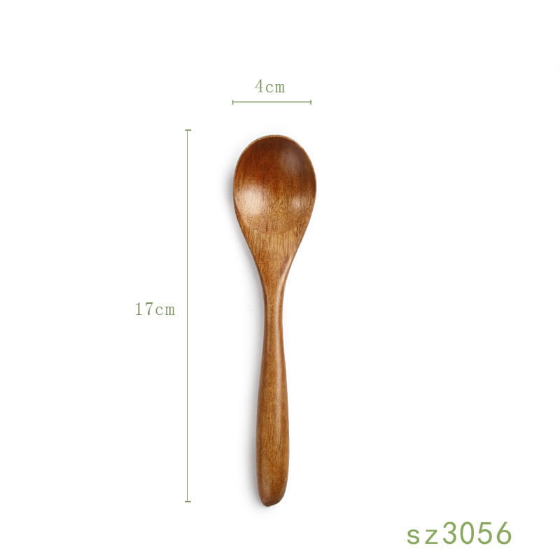 A smooth light brown handcrafted japanese wooden honey spoon made from hemu wood with a natural grain pattern and a rounded bowl.