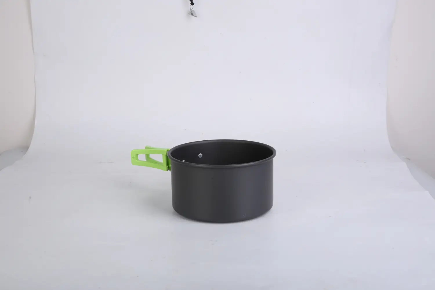 Black aluminum camping pot with bright green plastic handle from a camping cookware set 16pcs outdoor pot pan kettle kit.