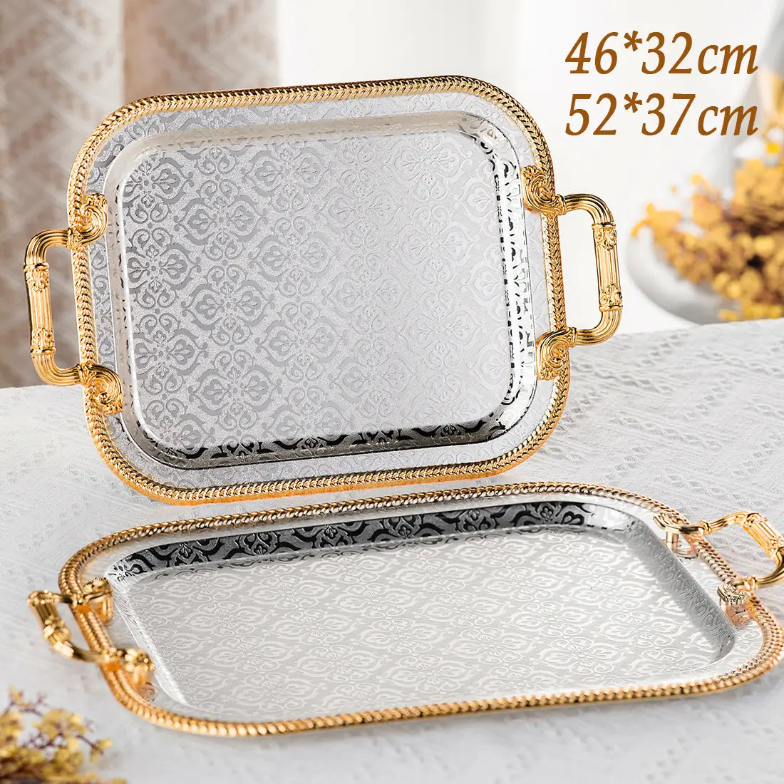 Luxury rectangle serving tray with gold-tone bamboo-style handles and a silver-toned embossed damask surface available in two sizes.