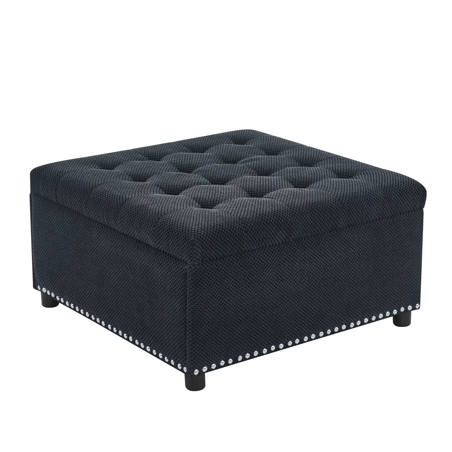 Black tufted storage ottoman in dark navy textured fabric with silver nailhead trim for versatile seating and storage.