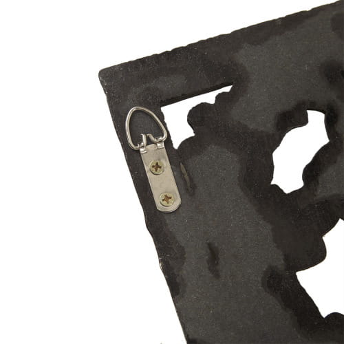 black metal wall hanging with cutout design and silver-toned mounting hardware for carved wood wall decor set distressed botanical panels.