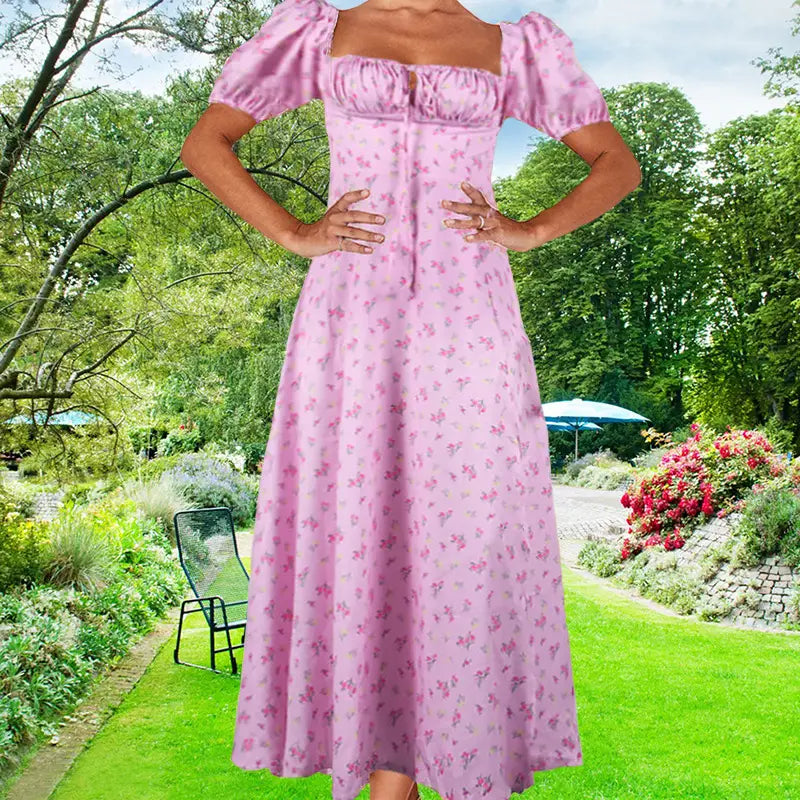 A soft pink floral print midi dress with puffed short sleeves, a square neckline, and a slit, ideal for elegant occasions.