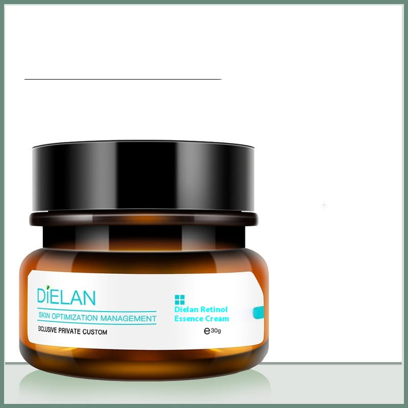 Ein elegantes Bernstein-Glasbehältnis mit einem glänzenden schwarzen Deckel, beschriftet mit „dielan retinol essence cream“ in türkisfarbenem und weißem Text, enthaltend Retinol-Gesichtspflegecreme gegen vorzeitige Hautalterung und zur Straffung, 30 ml.