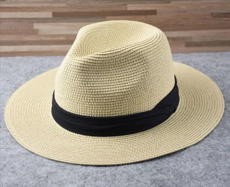 Beige straw fedora hat with a black ribbon band designed for foldable sun protection for men.