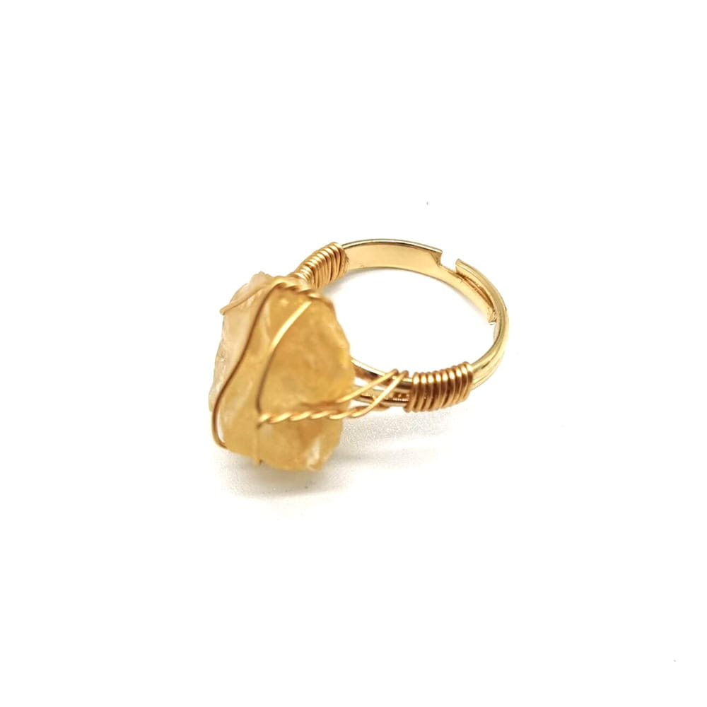 Handcrafted raw gemstone gold wire wrapped adjustable ring featuring a gold-toned wire and a translucent yellow citrine stone.