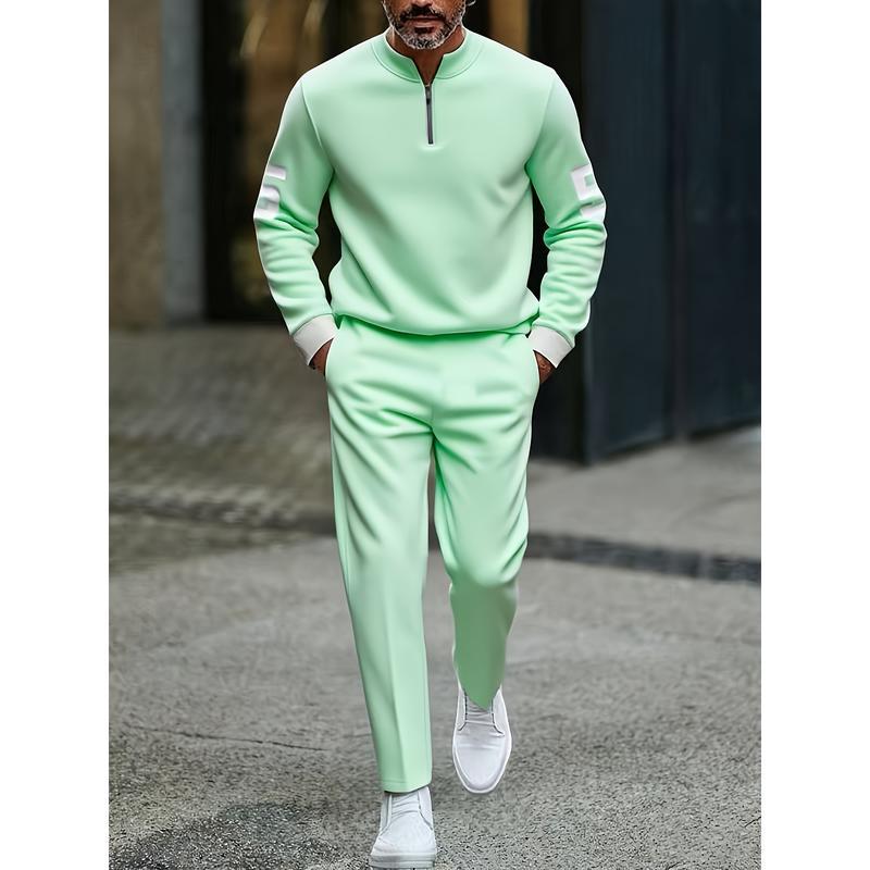 mint green half zip athletic sweatshirt with white sleeve accents and matching sweatpants made from comfortable fabric for casual and athletic wear.