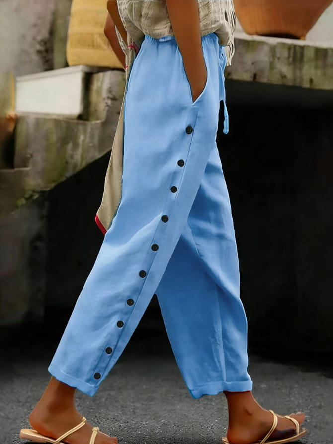 light blue loose-fitting cropped patchwork casual pants for women with black buttons running down the side seam