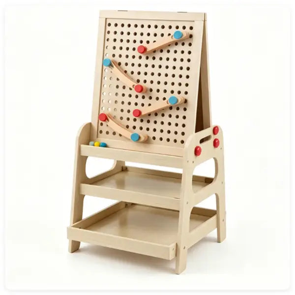 Beige wooden art easel with marble run featuring colorful red and blue marbles rolling along curved tracks and storage shelves.