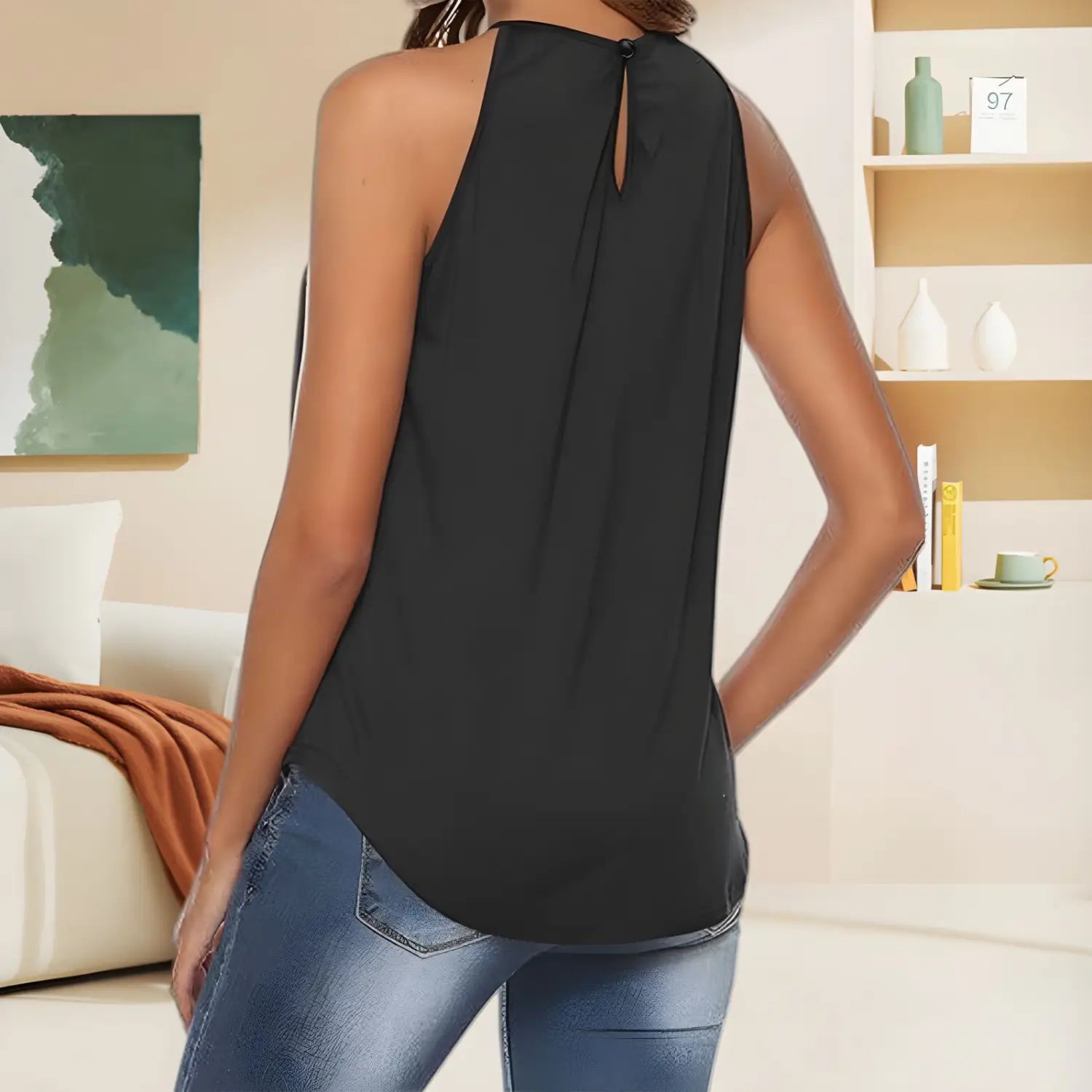 black sleeveless embroidered halter camisole with keyhole back detail and flowing lightweight fabric shown from the back