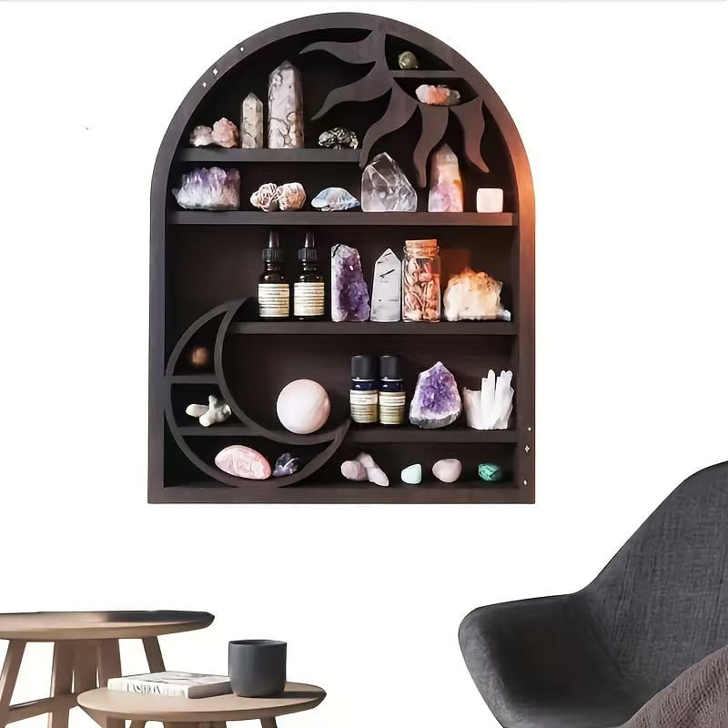 Dark wood black wooden arched sun floating shelf with moon and sun cutouts displaying crystals minerals and essential oil bottles for crystal display and organization.