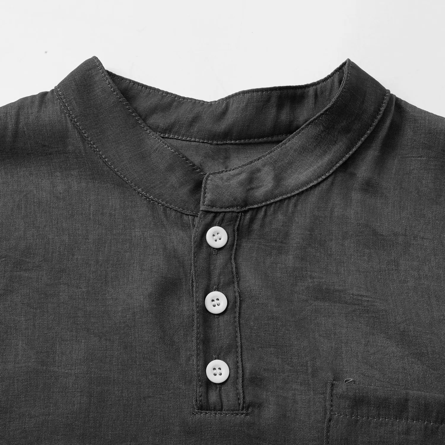 Men’s slim fit sleeveless denim henley shirt in black linen with a mandarin collar and three white buttons.