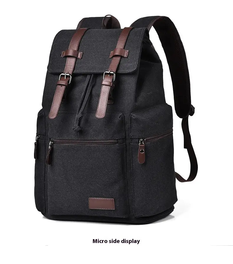 Black canvas men’s travel backpack with large 20-35l capacity featuring brown leather straps and buckles.