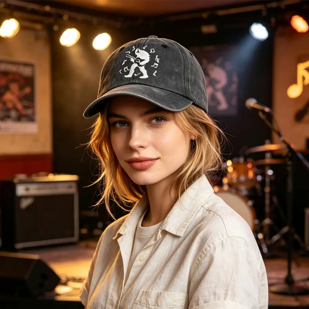 Dark gray distressed baseball cap featuring a white embroidered graphic of a guitarist surrounded by musical notes titled Bigfoot Guitar Baseball Cap vintage distressed hat.