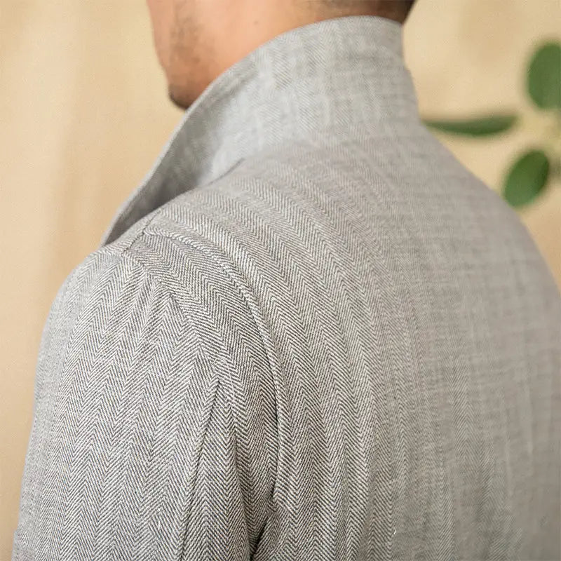 A light gray herringbone-patterned cotton linen M65 safari jacket with a structured collar and subtle texture.