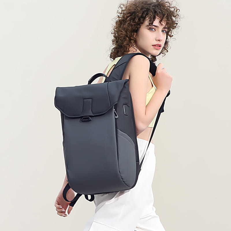 Dark gray minimalist laptop backpack with sleek modern design black straps and usb charging port suitable for school and daily use.