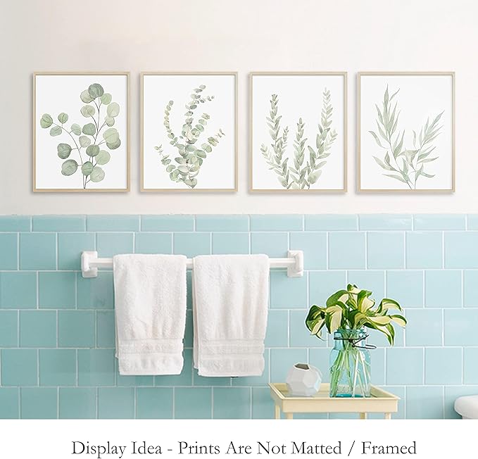Set of four framed botanical canvas wall art prints featuring delicate green and gray eucalyptus leaf illustrations in minimalist light wood frames for decorative use.