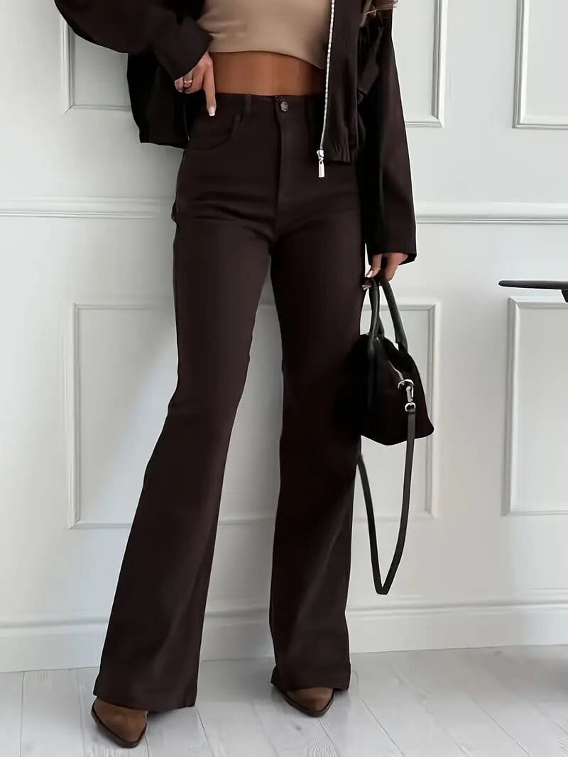 Brown high waisted flared jeans in dark brown with visible stitching and a sleek straight leg cut.