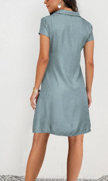 A light blue plus size short sleeve button front dress made of tencel denim with a collar.