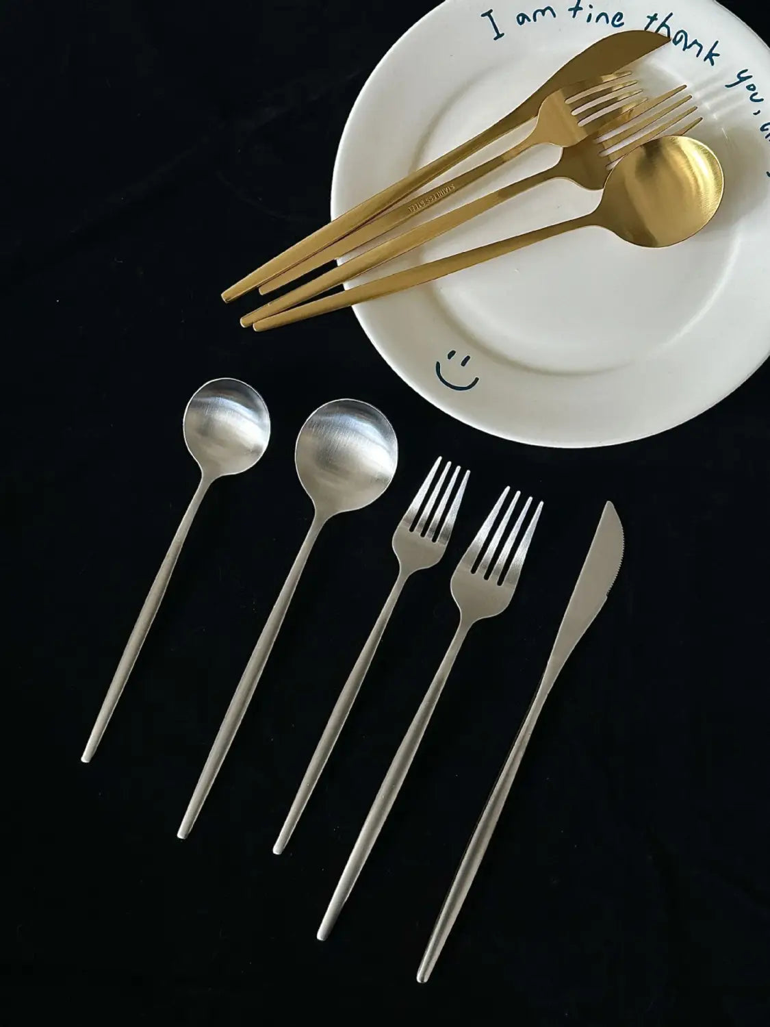 Gold-finished stainless steel matte cutlery set featuring a sleek modern design with minimalist handles.