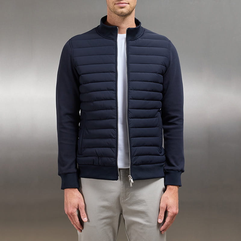 Navy blue quilted lightweight bomber jacket for men with a stand collar and zipper closure designed for casual wear.