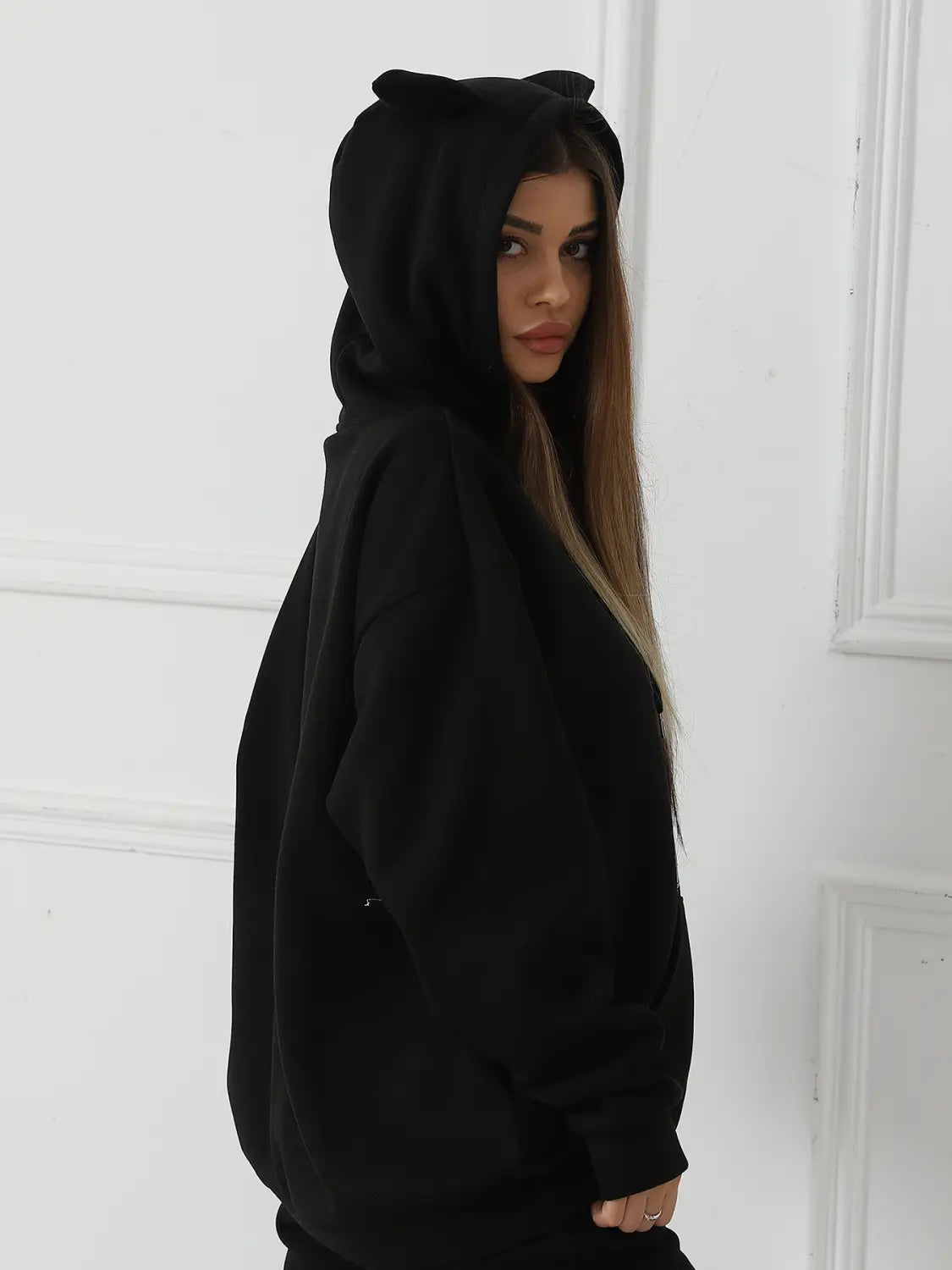 black women’s dalmatian print hoodie featuring a cat ear hood design shown from the back side
