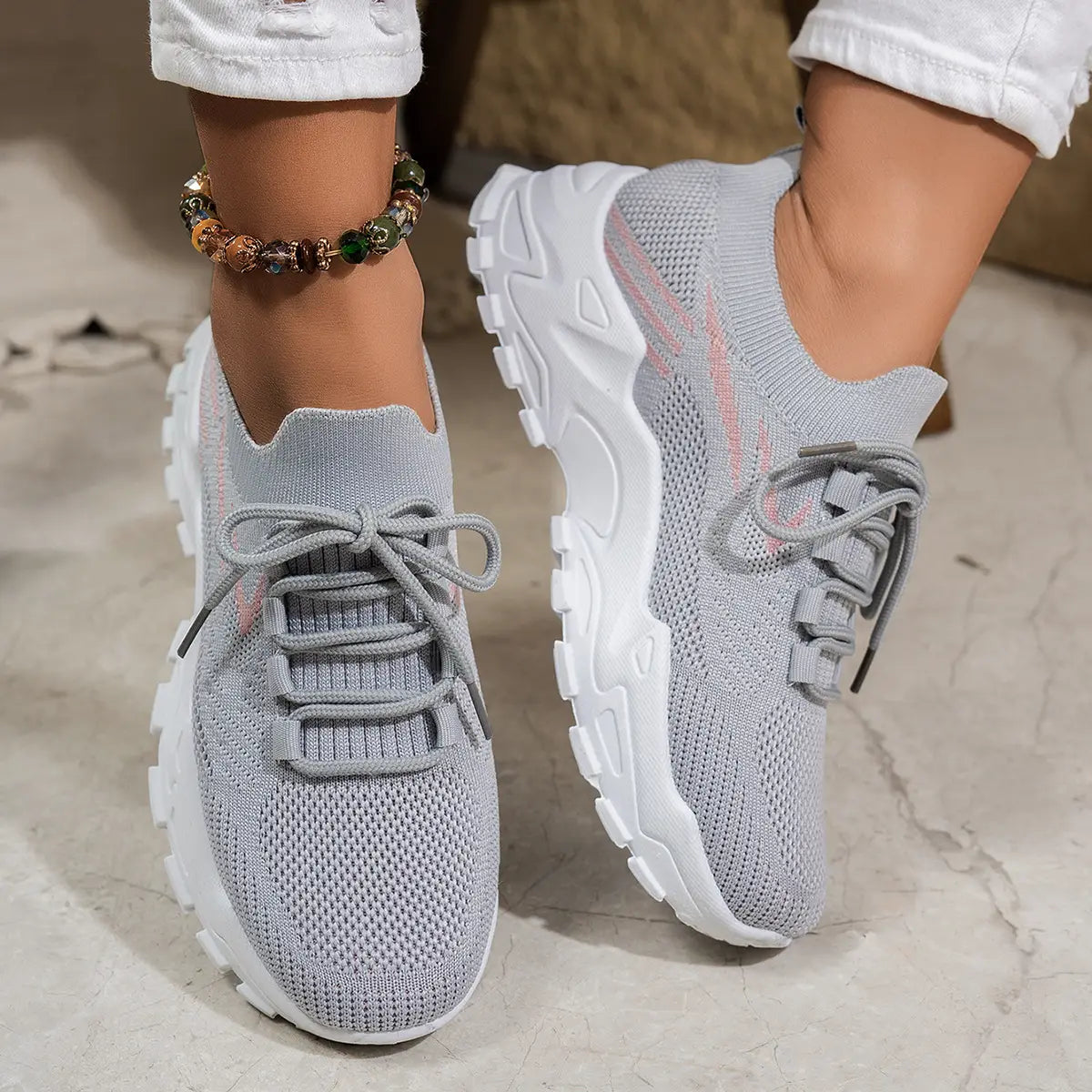 women’s lightweight breathable mesh lace up sports shoes in gray knit with chunky white sole and pink accents