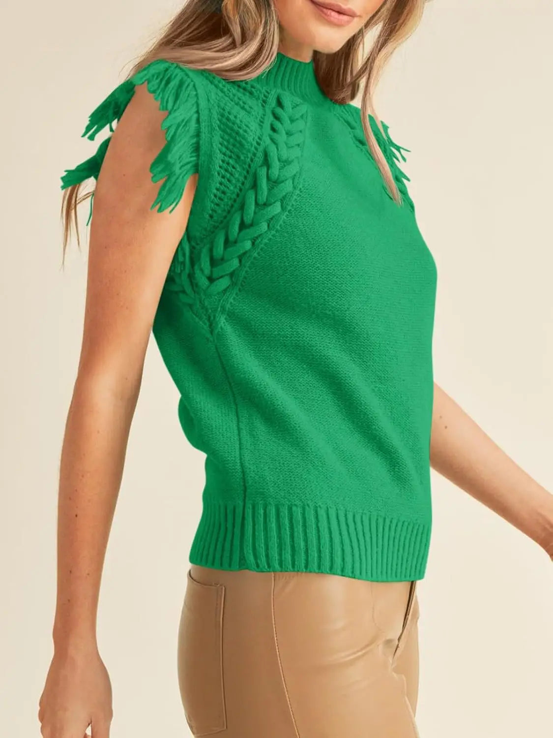 Vibrant green hand-woven fringed sleeveless knit sweater vest featuring fringe detailing on the shoulders and a braided texture running down the side.
