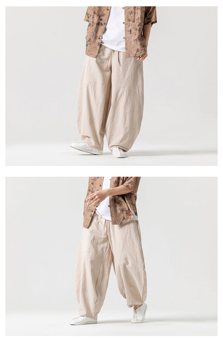 Pantalon ample en toile de tai-chi beige, coupe ample et décontractée, jambe large avec découpe décontractée et plis discrets.
