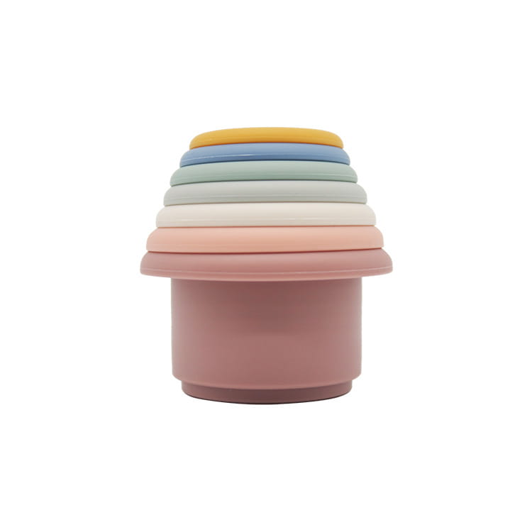 pastel-colored silicone stacking cups in a rainbow gradient from yellow to dusty rose designed as an educational nesting baby toy.