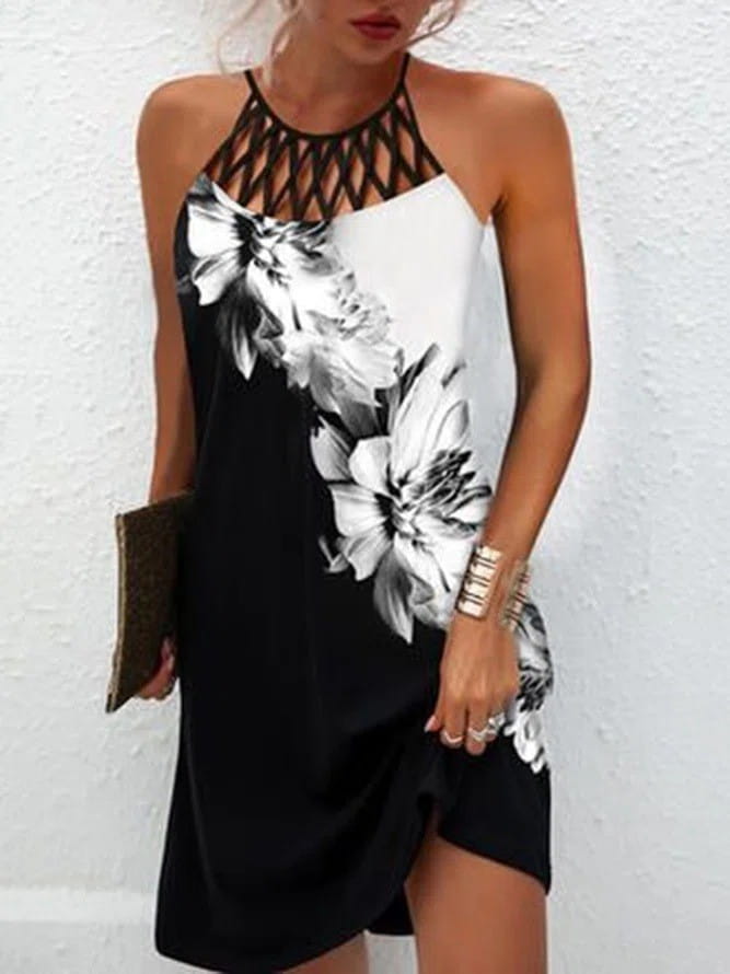Black and white floral print halter dress with a lace-up neckline featuring an asymmetrical midi hemline.