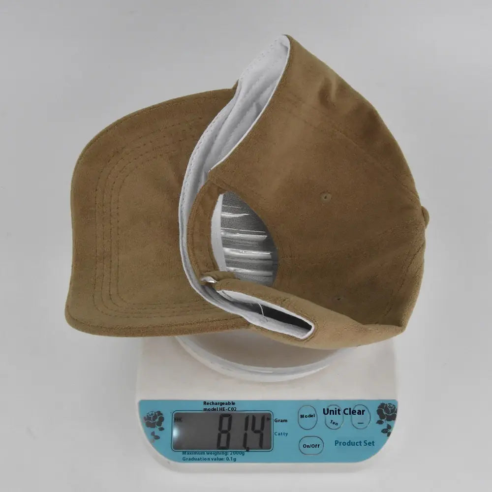 Tan suede baseball cap with white interior lining and silver-toned adjustable strap shown from the back side in a soft minimalist adjustable hat design.