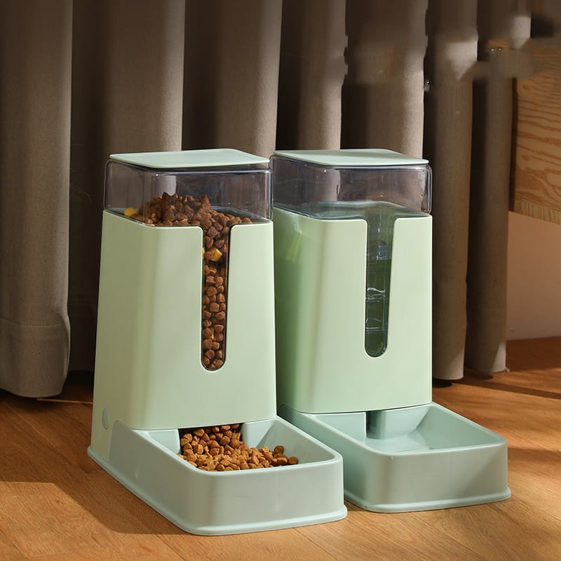 Mint green automatic pet feeder and water dispenser set with transparent compartments for food and water storage.