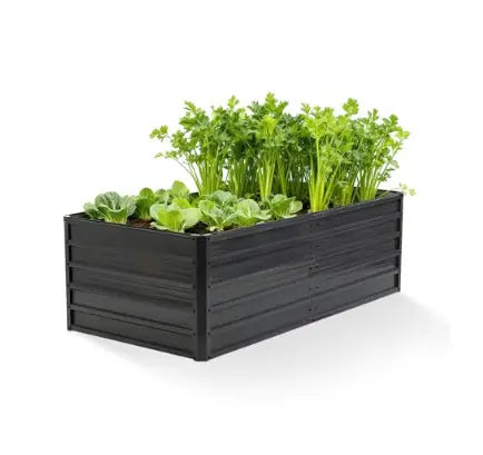 Black metal raised garden bed with galvanized finish and horizontal slats filled with lush green leafy vegetables in a 6x3x2ft planter box.
