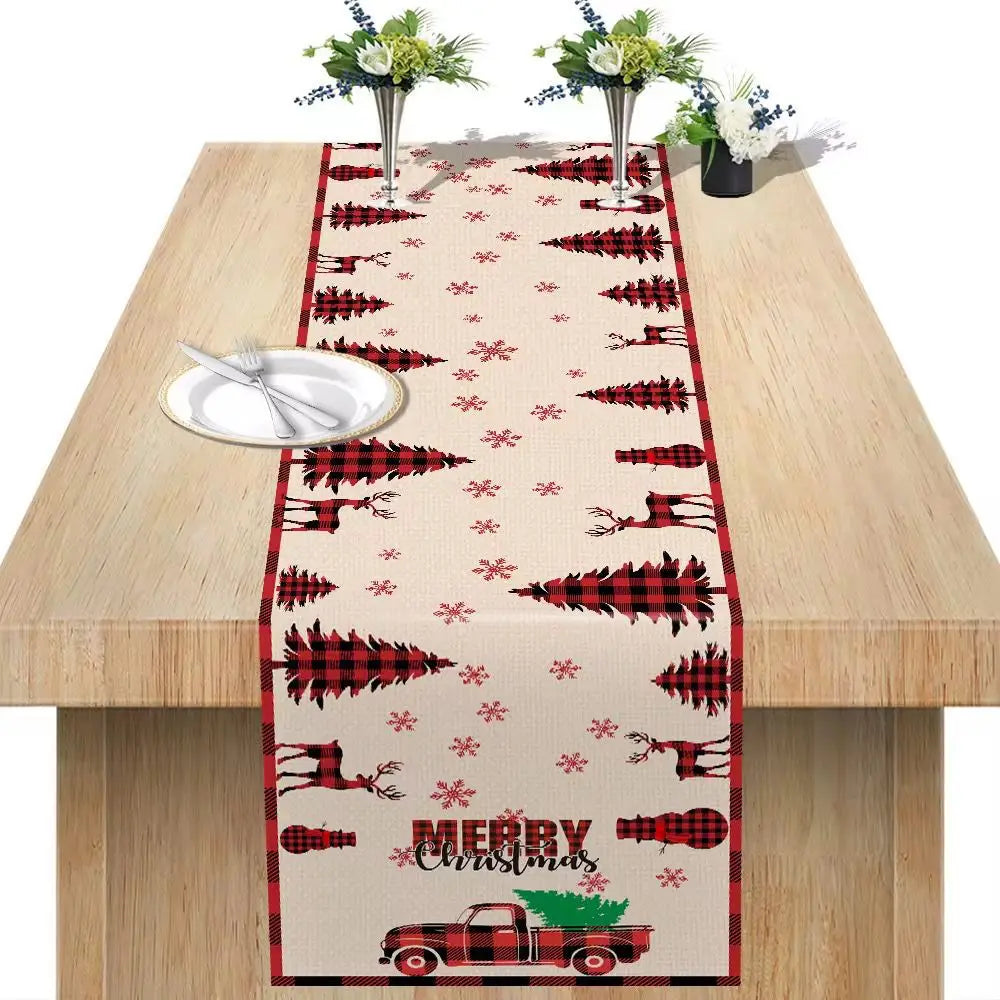 Christmas table runner festive holiday decor in red and black plaid featuring reindeer snowflakes and a truck carrying a tree measuring 183x33 inches.