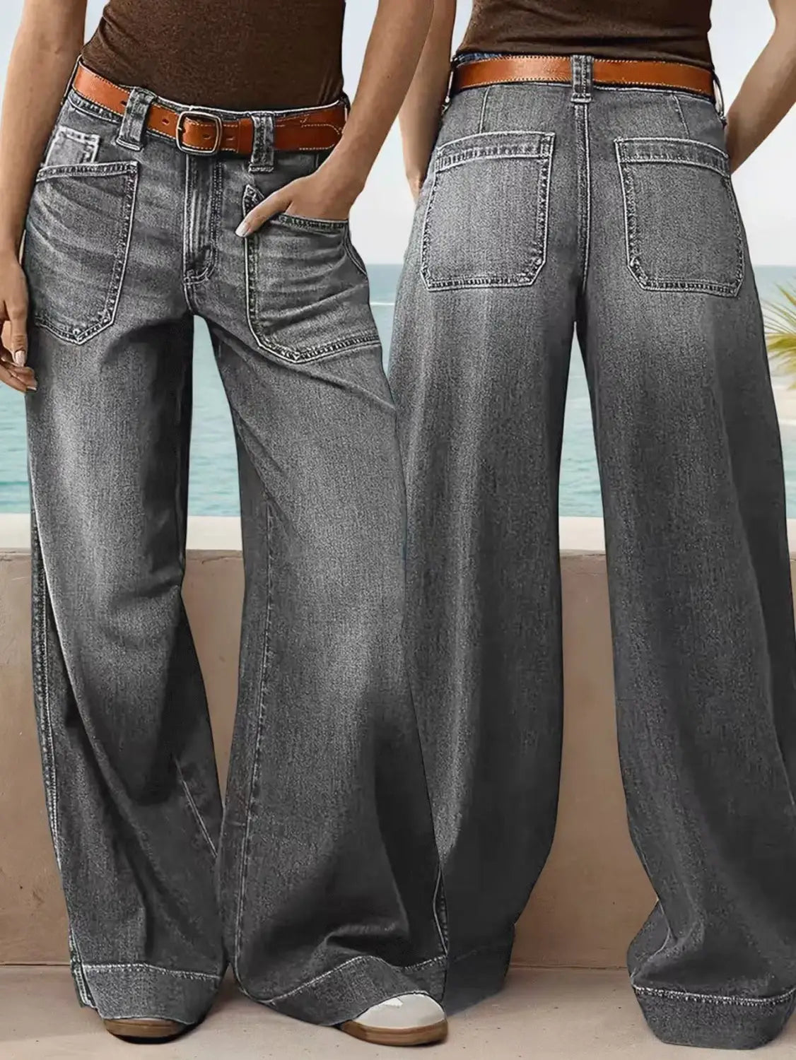 Wide leg denim pants in faded gray wash paired with a brown leather belt.