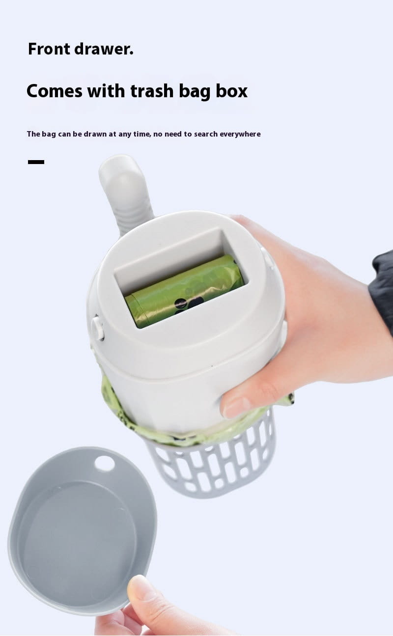 White plastic integrated cat litter scoop with green trash bag roll and perforated base for pet waste disposal.