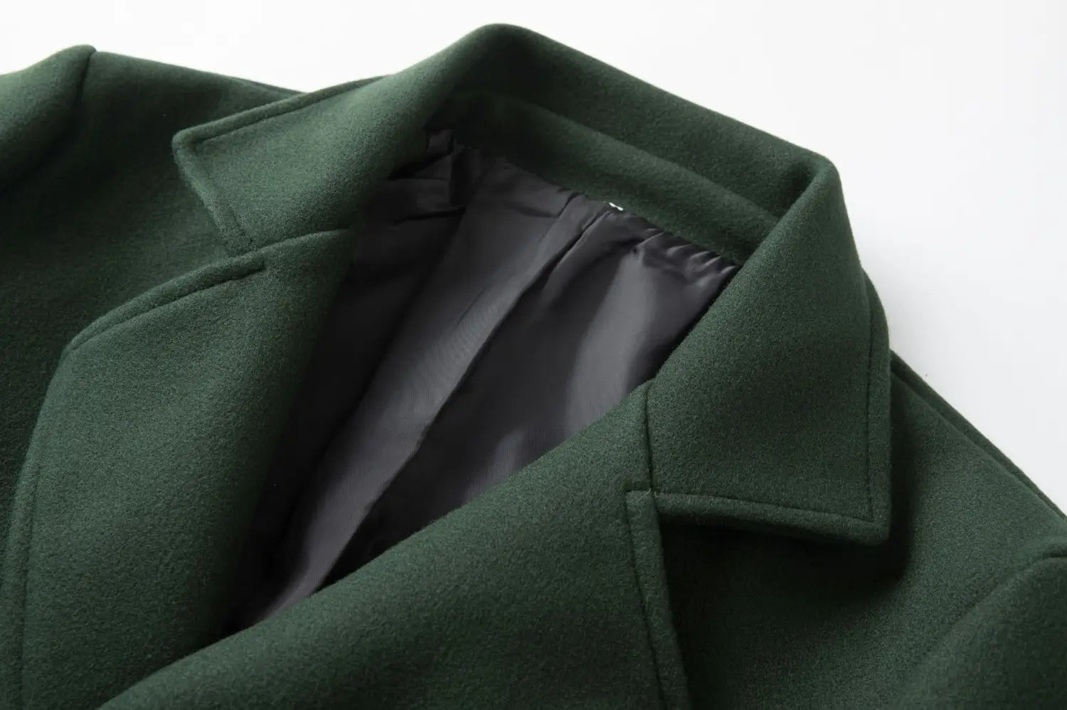 men double breasted dark green wool overcoat with structured collar and black inner lining mid length coat