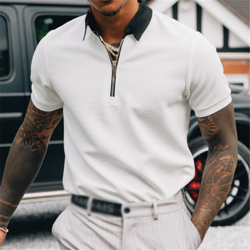 Men’s textured white polo shirt featuring short sleeves black collar and zipper placket.