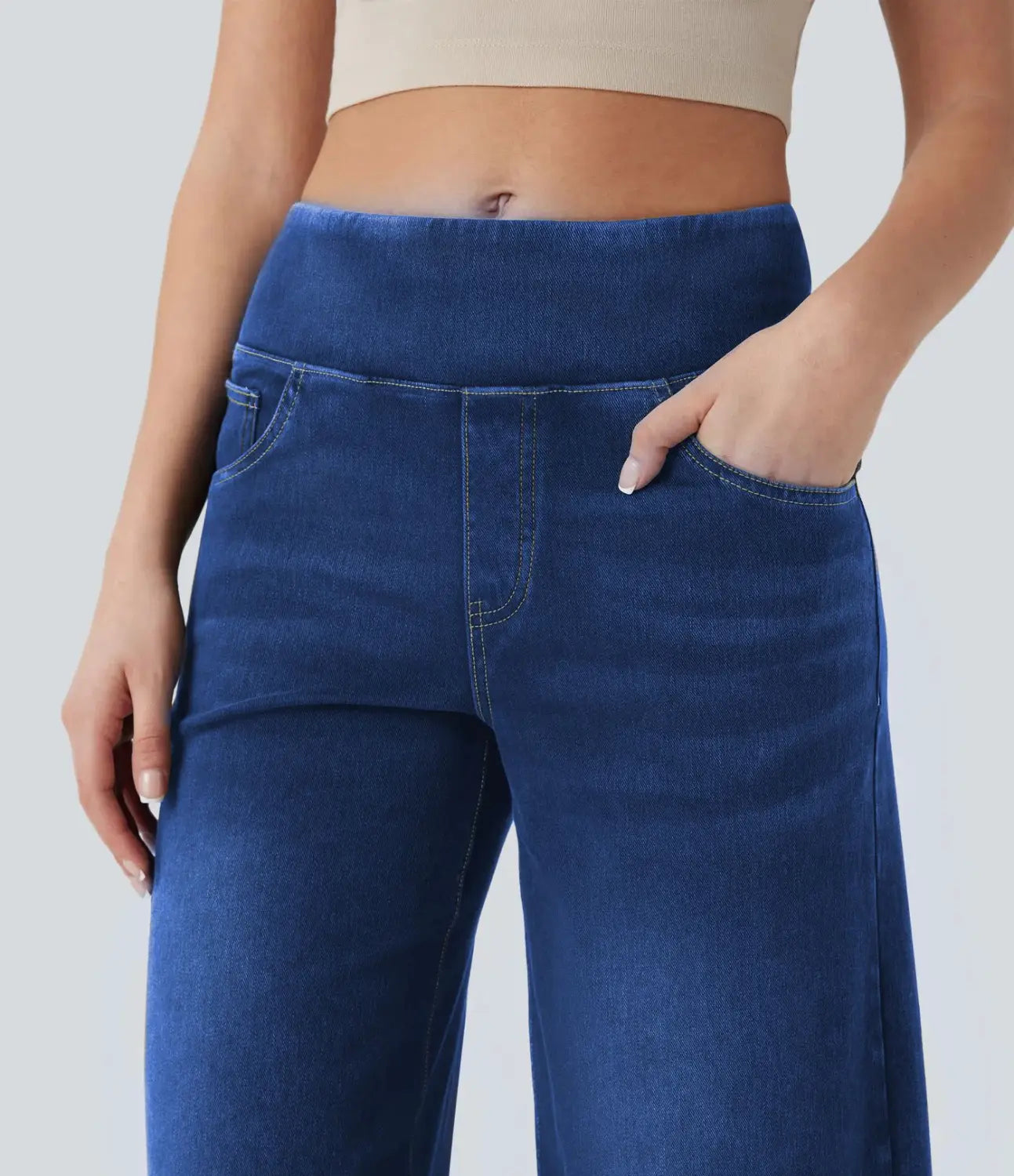 Dark blue denim wide leg jeans featuring a high waist and a comfortable elastic waistband with classic front pockets.
