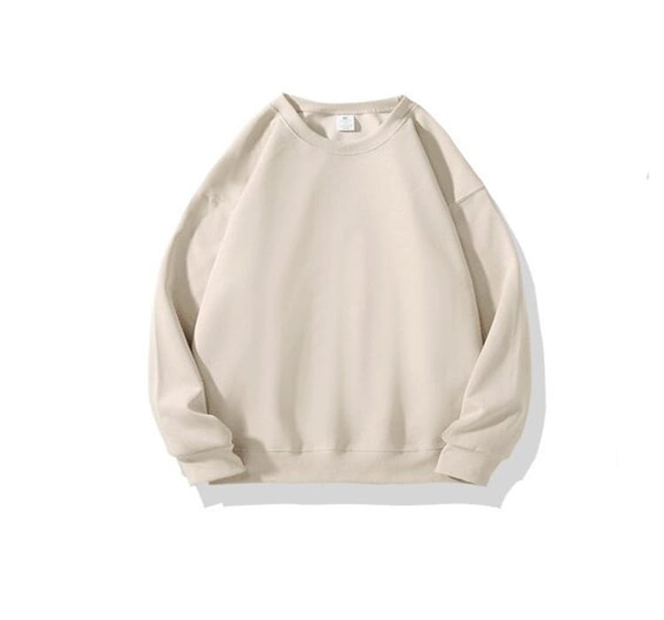 Sudadera tipo crewneck de algodón oversize en color beige, con tejido de algodón suave y un diseño sencillo.