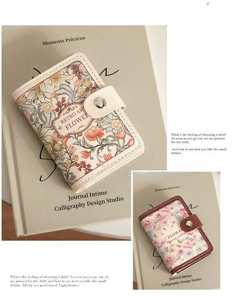 A delicate cream-colored vintage floral leather card holder wallet with a silver-toned snap closure.