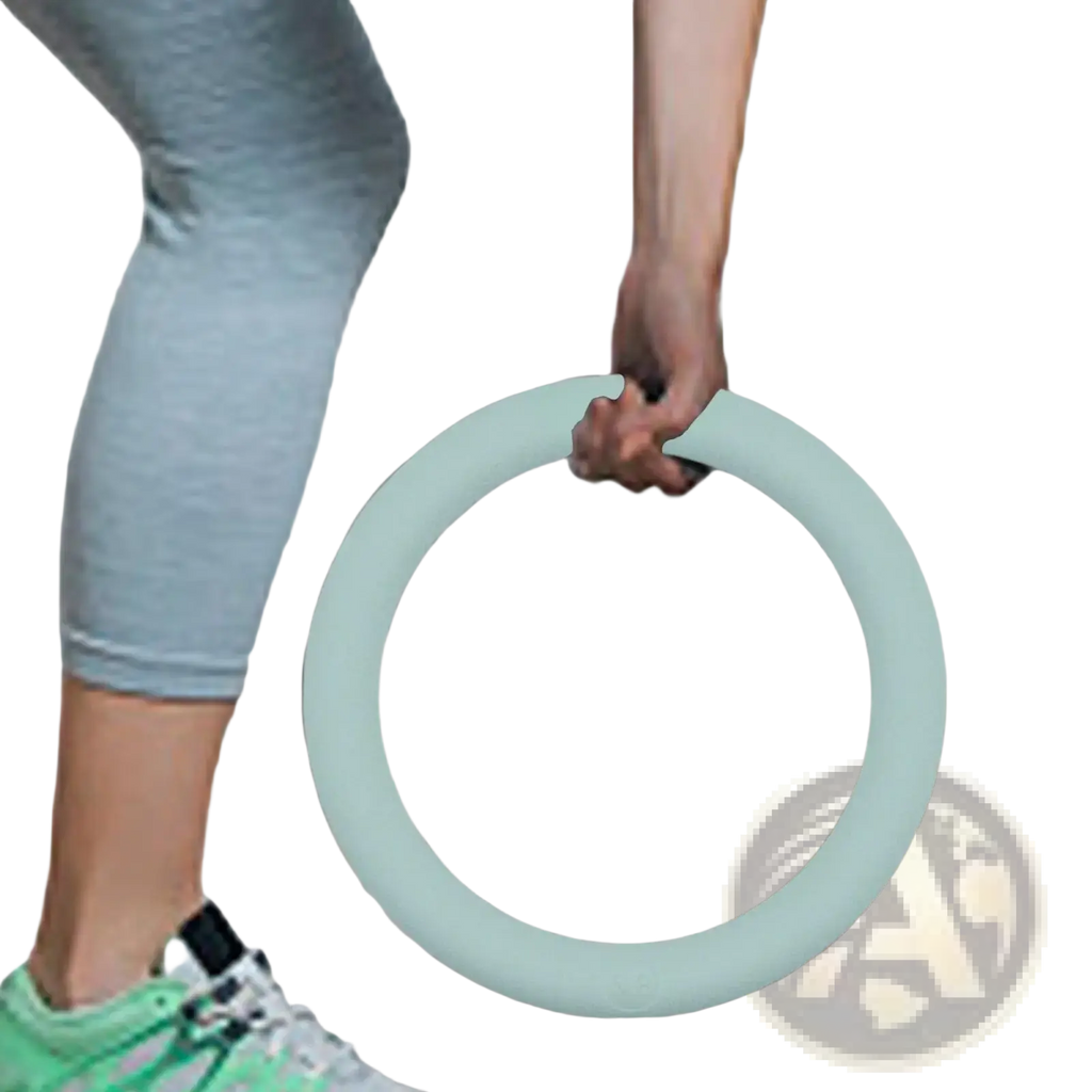A mint green foam 5lb weighted fitness ring held by a hand for Pilates and strength training exercises