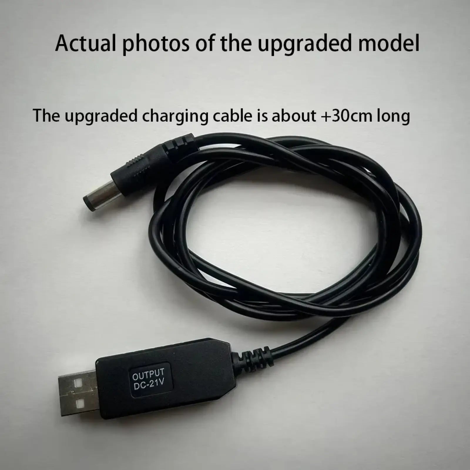 Black usb-to-dc charging cable with 5v to 21v boost adapter and coiled design for versatile power delivery
